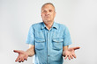 © amixstudio - Elderly pensioner throws up his hands in surprise, does not know what to do on white studio background isolated