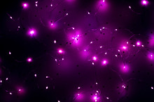 Cold White LED String Lights On Star Pattern Purple Background. Modern Festive Interior Decor.