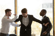 Male colleague set apart angry diverse businessmen fighting in office