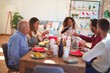 © Krakenimages.com - Beautiful family smiling happy and confident. Eating roasted turkey celebrating Christmas at home