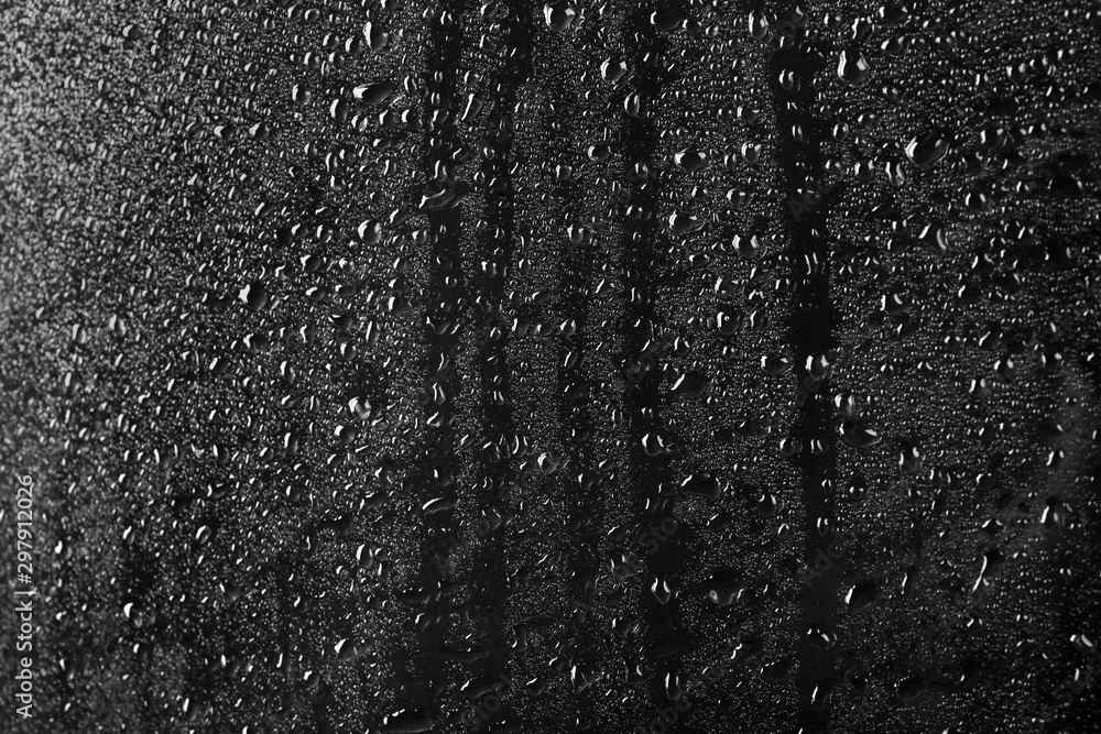 Glass with rain drops against dark background - obrazy, fototapety, plakaty 