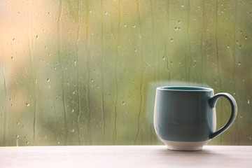 Poster - Cup of drink on windowsill, space for text. Rainy weather