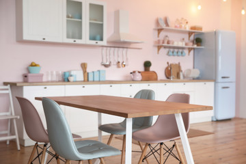 Wall Mural - Stylish kitchen interior with dining table and chairs