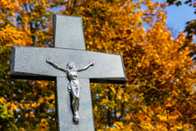Monument On The Gravestone. Tombstone With A Big Christian Cross. All Saints Day. Christian Cemetery In The Autumn.