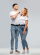 © Syda Productions - love, valentines day and relationships concept - portrait of happy couple in white t-shirts ready for kiss over grey background
