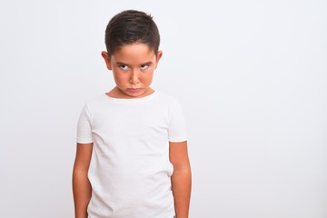 Sticker - Beautiful kid boy wearing casual t-shirt standing over isolated white background skeptic and nervous, frowning upset because of problem. Negative person.