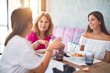 © Krakenimages.com - Beautiful group of women sitting at restaurant eating food speaking and smiling