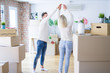 © Krakenimages.com - Young beautiful couple dancing at new home around cardboard boxes