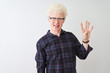© Krakenimages.com - Young albino blond man wearing casual shirt and glasses over isolated white background showing and pointing up with fingers number four while smiling confident and happy.