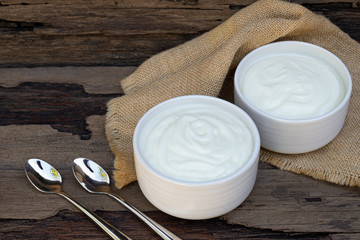 Yogurt  In white glass wood background from top view.