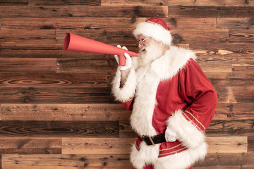 Wall Mural - Santa Claus screaming through a huge megaphone.