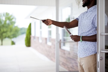 Canvas Print - Closeup shot of a person giving out pamphlets with a blurred background