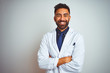 © Krakenimages.com - Young smiling doctor standing against white background