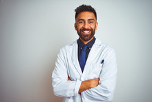Young Smiling Doctor Standing Against White Background