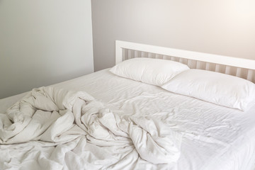 Two white pillow on bed with wrinkle messy blanket in bedroom