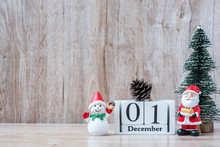 1 December Calendar With Christmas Decoration, Snowman, Santa Claus And Pine Tree  On Wooden Table Background, Preparation For Holiday, Happy New Year And Xmas Concept
