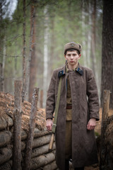 Wall Mural - A soldier of World War II is standing in the trench