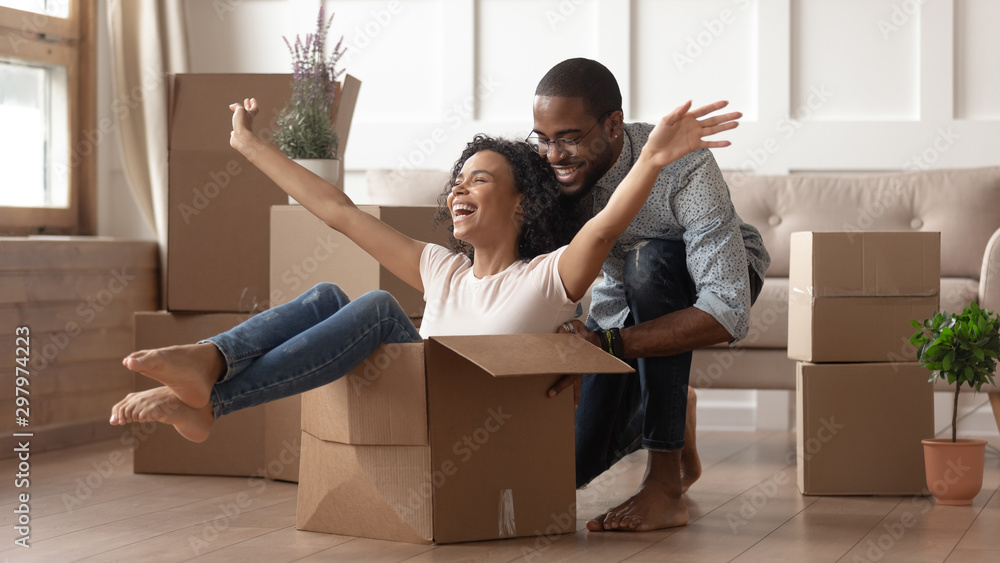 Happy black young couple have fun on moving day - obrazy, fototapety, plakaty 