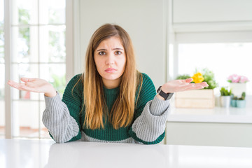 Canvas Print - Young beautiful plus size woman wearing casual striped sweater clueless and confused with open arms, no idea concept.