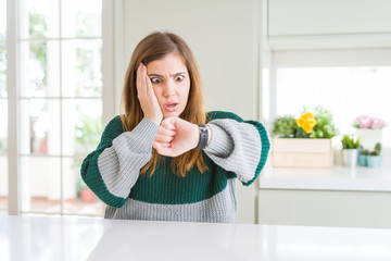 Poster - Young beautiful plus size woman wearing casual striped sweater Looking at the watch time worried, afraid of getting late