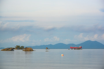 Sticker - Thap Kaek Beach, Krabi Province, Thailand. The big red boat, sea view, islands and clouds reflecting the water in the morning is a beautiful sea and popular with tourists.