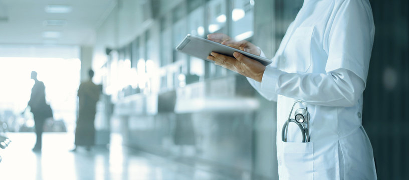 healthcare and medicine. medical and technology. doctor working on digital tablet on hospital backgr