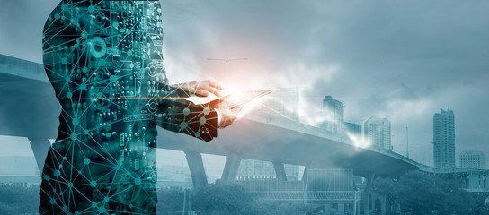 Poster - Business and digital technology concept, Network connection, Businessman using tablet analyzing sales data and financial trading on city background.