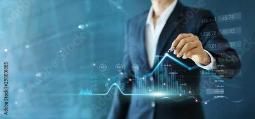 Fotomural Businessman draw growth graph and progress of business and analyzing financial and investment data ,business planning and strategy on blue background