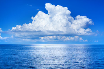 white cumulus clouds in blue sky over sea landscape, big cloud above ocean water panorama, horizon, 