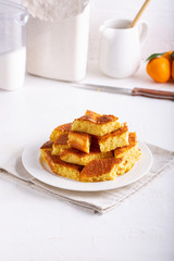 Wall Mural - Homemade citrus sponge cake. Orange biscuit on white table.