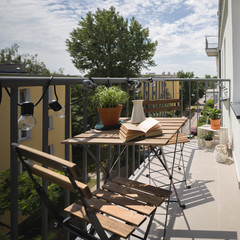 Canvas Print - Wooden table on a balcony