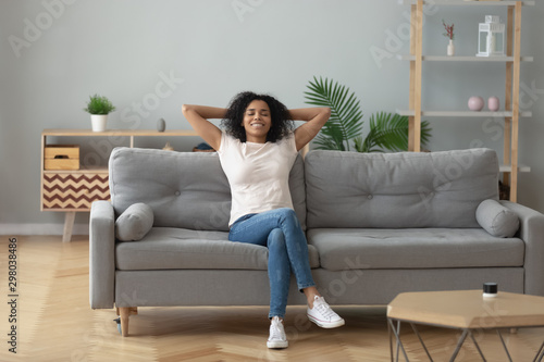 Fotografía Happy black girl relaxing on cozy sofa at home