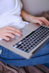 Wall Mural - closeup female hands typing on laptop keyboard.