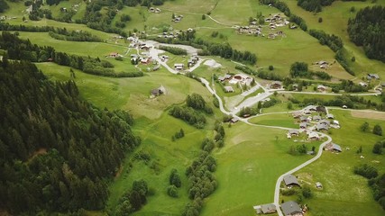 Wall Mural - Aerial tracking shot of valley village in French mountains