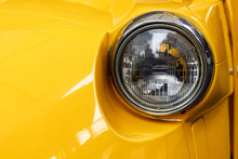 Closeup Headlights Of Yellow Car.