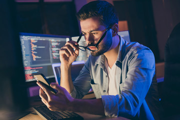Photo of it-specialist work late at night sit office chair read telephone team email solve problem website debugging expert correct service error dark office indoors