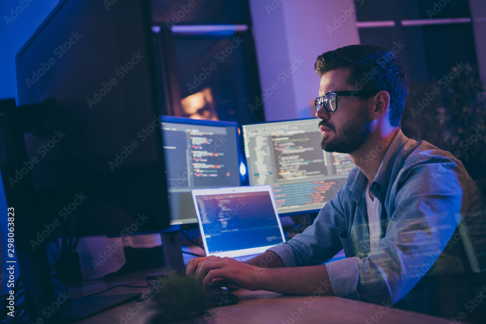Profile side view portrait of his he nice attractive skilled focused serious guy writing script ai tech support devops creating digital solution front-end in dark room workplace station indoors - obrazy, fototapety, plakaty 