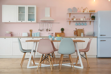 Wall Mural - Stylish kitchen interior with dining table and chairs