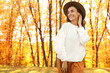 © New Africa - Beautiful happy woman wearing hat in park. Autumn walk