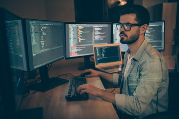Photo of serious administrator responsible for cyber security of large corporation searching for safety gaps debugging existant operating system to reduce hacker attacks success probability