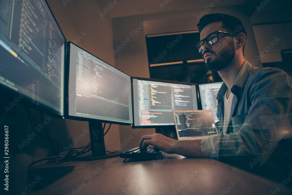 Profile side view of nice attractive serious skilled qualified smart clever bearded brunet guy nerd building fixing extracting file editing framework web design in dark beige room workplace station - obrazy, fototapety, plakaty 