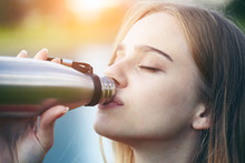 Pretty Young Blonde Woman Drinking Water, Using Stainless Steel Instead Of Single-use Plastic Bottle