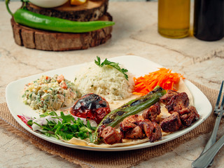 Poster - meat kebab with rice and vegetables on the table