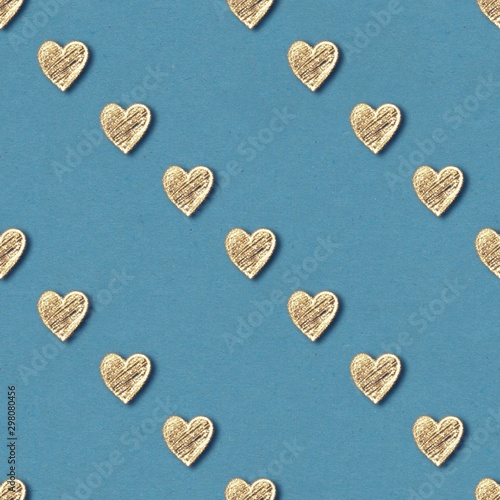 Golden hearts seamless pattern. Gold glitter on blue old paper background