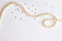 Pearls On White Table Background