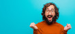 Leinwandbild Motiv young bearded crazy man feeling shocked, excited and happy, laughing and celebrating success, saying wow! against flat color wall