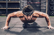 © Aparicio Febrer/ADDICTIVE STOCK - strong and athletic man doing push-up workout in modern gym
