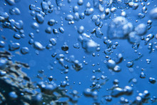 Background Of Oxygen Bubbles Rising Up To Surface Of Sea In Clear And Transparent Water