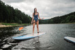 © Léa Jones/Stocksy - teen girl on paddle board on lake in France