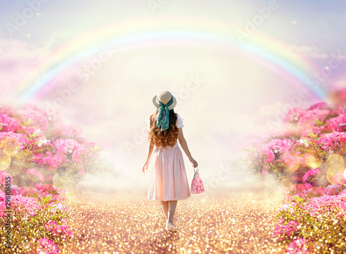 young-lady-woman-in-romantic-pink-dress-retro-hat-bag-walking-along-rose-garden-path-leading-to-fabulous-rainbow-unicorn-house-flecks-of-sunlight-on-road-tranquil-fantasy-scene-fairytale-hills